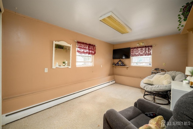 living area featuring carpet, a baseboard radiator, and a healthy amount of sunlight