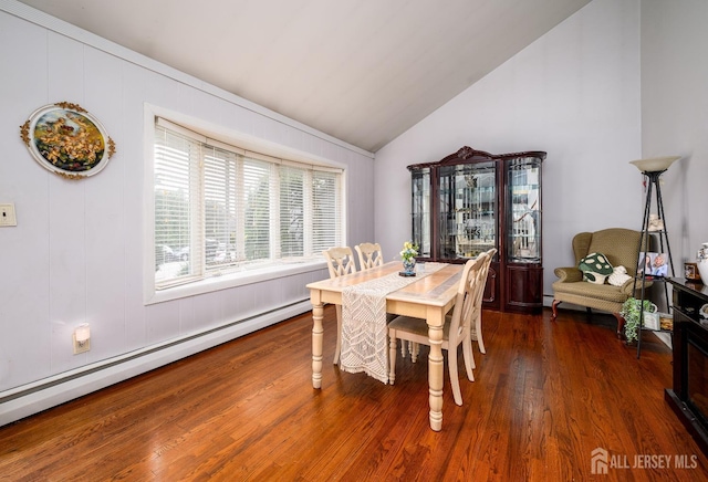 dining room with lofted ceiling, baseboard heating, and wood finished floors