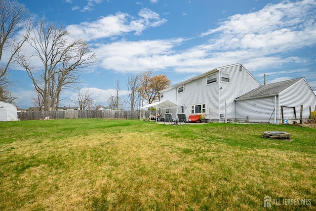 view of yard featuring a fenced backyard, a patio area, and an outdoor fire pit