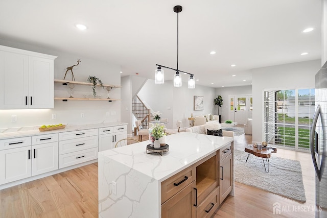 695 Inman Ave, Colonia, NJ 07067 - kitchen with recessed lighting, light wood-style floors, open shelves, a center island, and hanging light fixtures