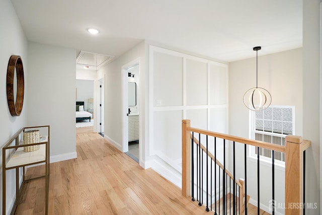 695 Inman Ave, Colonia, NJ 07067 - hallway with attic access, an upstairs landing, and light wood-style flooring