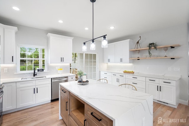 695 Inman Ave, Colonia, NJ 07067 - kitchen with open shelves, dishwasher, light wood-type flooring, white cabinets, and a center island