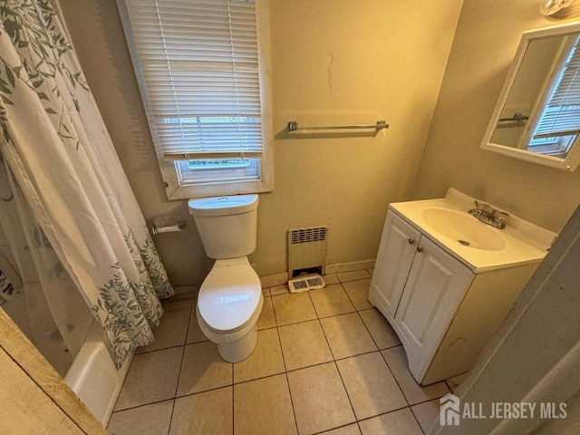 bathroom with baseboards, toilet, radiator heating unit, tile patterned flooring, and vanity