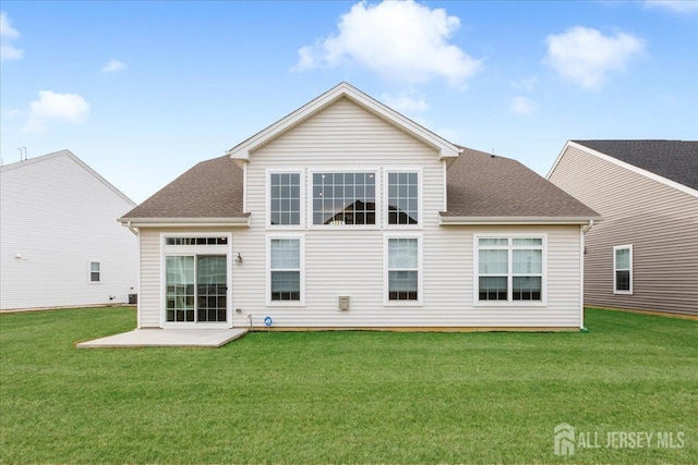 back of property with a lawn and a patio area