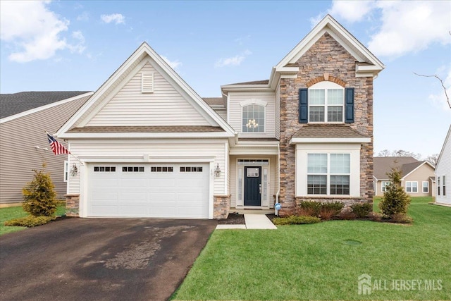 view of front of house featuring a garage and a front lawn