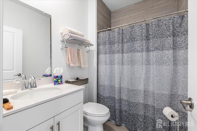 bathroom featuring vanity and toilet