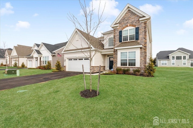 view of front of house featuring a garage and a front lawn