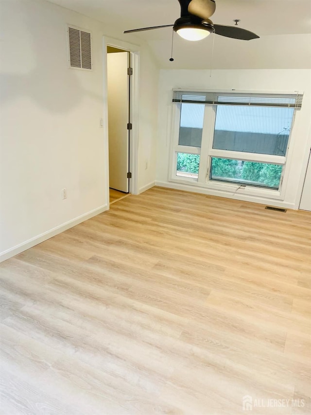 empty room with ceiling fan and light wood-type flooring