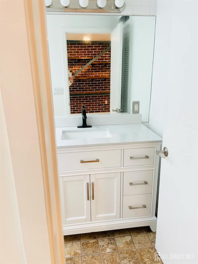 bar with white cabinetry and sink