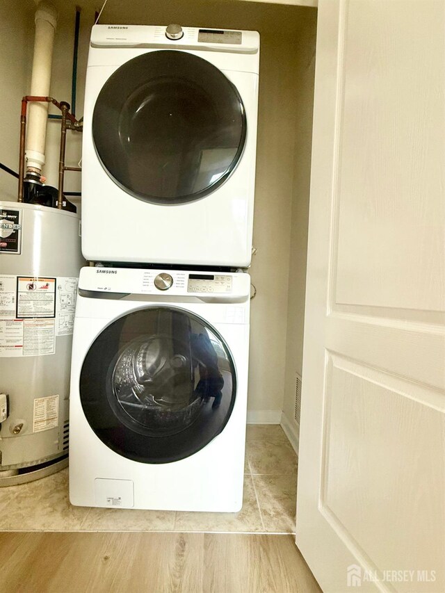 2024 Edward Stec Blvd, Edison, NJ 08837 - laundry area with estacked washer and dryer and water heater