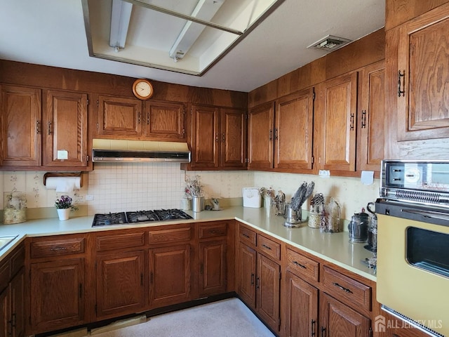 309-C Sharon Way, Monroe, NJ 08831 - kitchen featuring wall oven, under cabinet range hood, gas stovetop, light countertops, and brown cabinetry