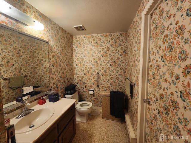 309-C Sharon Way, Monroe, NJ 08831 - bathroom featuring vanity, toilet, and wallpapered walls