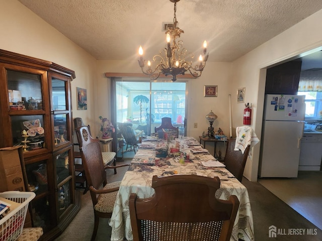 309-C Sharon Way, Monroe, NJ 08831 - dining space with a chandelier, a textured ceiling, and carpet flooring