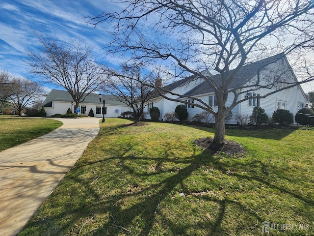 309-C Sharon Way, Monroe, NJ 08831 - view of front of house with driveway, a front lawn, and a chimney