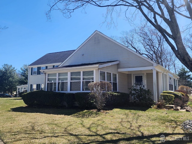 309-C Sharon Way, Monroe, NJ 08831 - rear view of property with a lawn, a sunroom, and roof with shingles