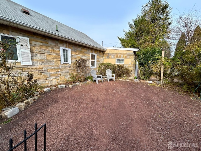 1515 Thomas Ave, North Brunswick, NJ 08902 - back of house with stone siding and roof with shingles