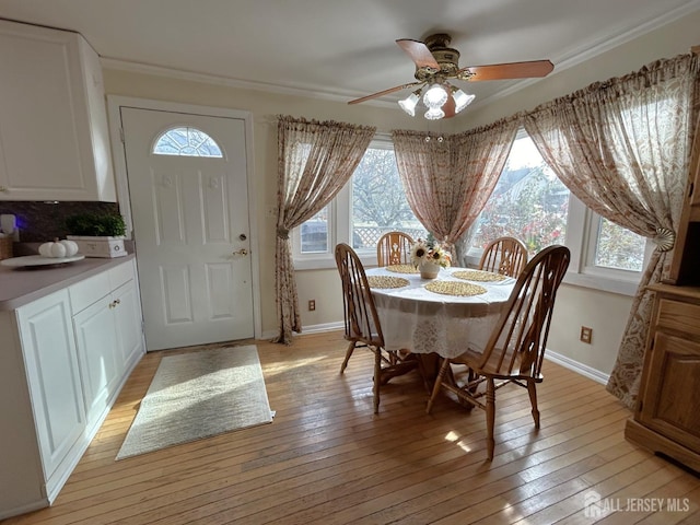 1515 Thomas Ave, North Brunswick, NJ 08902 - dining room featuring healthy amount of natural light, a ceiling fan, baseboards, and ornamental molding