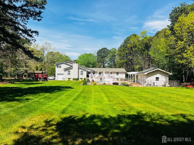 back of property featuring an attached garage and a yard