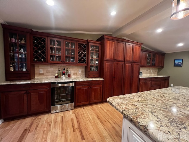 bar featuring tasteful backsplash, ornamental molding, wet bar, light wood finished floors, and beverage cooler