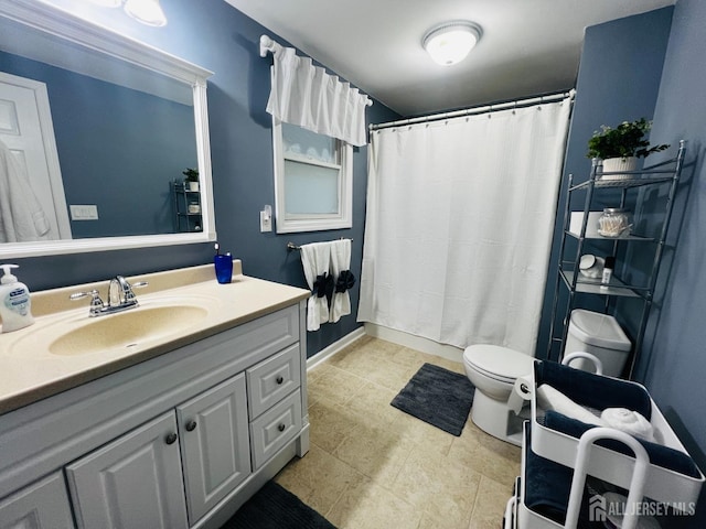 bathroom with vanity, toilet, and a shower with curtain