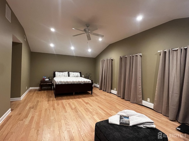 bedroom featuring lofted ceiling, a ceiling fan, light wood-style flooring, baseboards, and visible vents