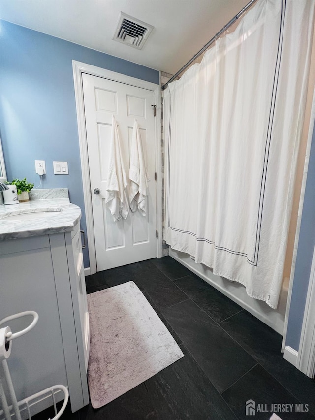 full bathroom featuring visible vents, vanity, and shower / tub combo with curtain