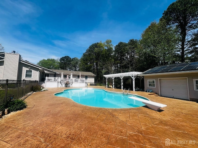 view of swimming pool with a patio, a diving board, fence, a pergola, and a fenced in pool