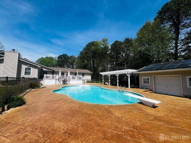 195 Old Forge Rd, Monroe, NJ 08831 - view of swimming pool featuring a pergola, a diving board, a patio area, fence, and view of wooded area