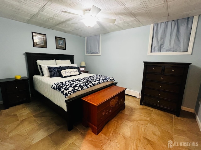 bedroom featuring baseboards, a ceiling fan, and a baseboard heating unit