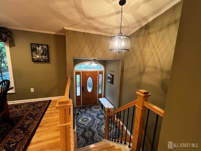 entryway featuring ornamental molding, baseboards, and wood finished floors