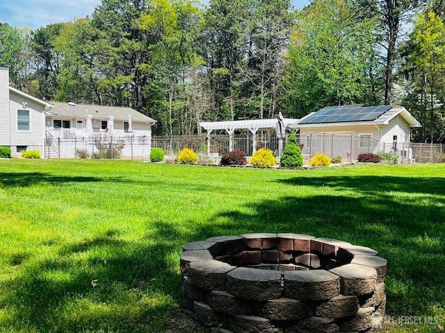view of yard with an outdoor fire pit and fence