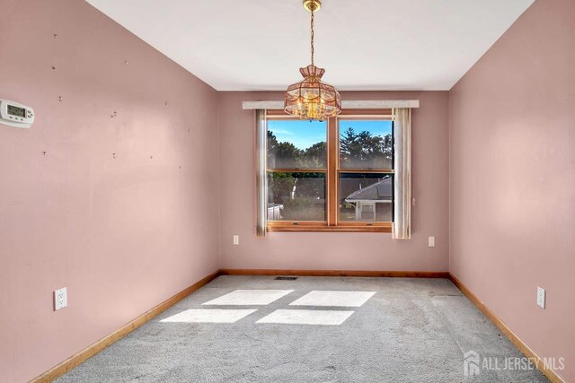 250 Adirondack Ave, Spotswood, NJ 08884 - carpeted spare room featuring a chandelier and baseboards