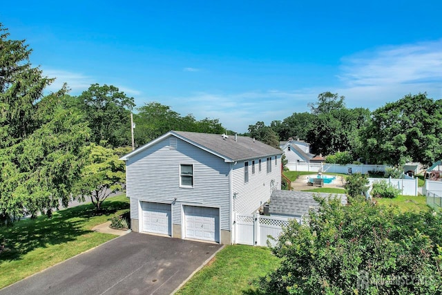 250 Adirondack Ave, Spotswood, NJ 08884 - view of side of property with asphalt driveway, a garage, and roof with shingles