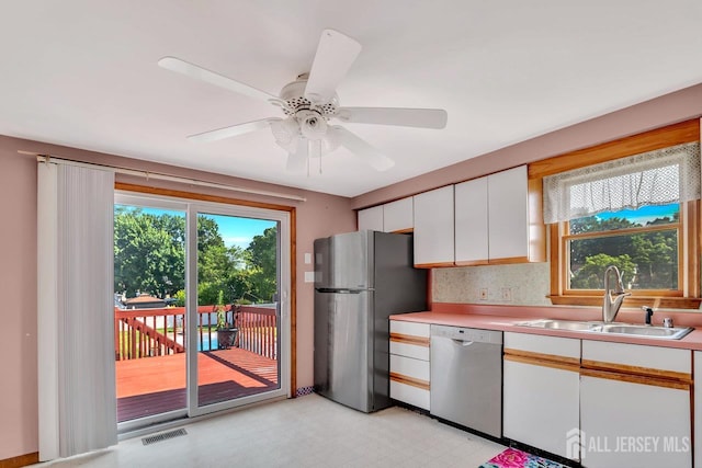 250 Adirondack Ave, Spotswood, NJ 08884 - kitchen featuring stainless steel appliances, light countertops, light flooring, white cabinetry, and a ceiling fan