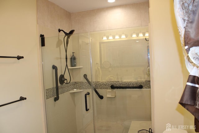 bathroom featuring a shower with door