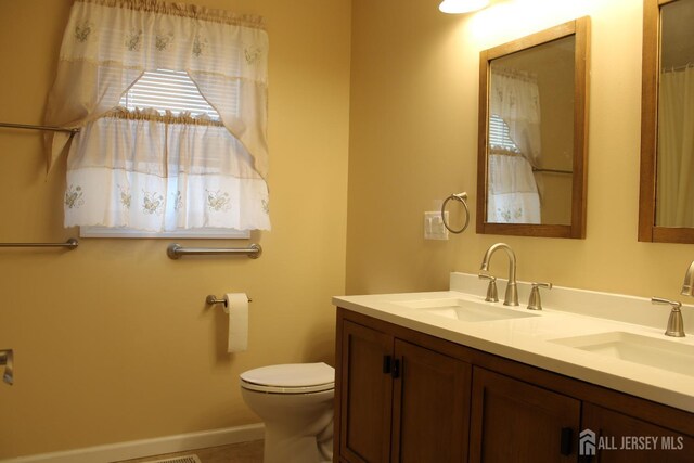 bathroom featuring vanity and toilet