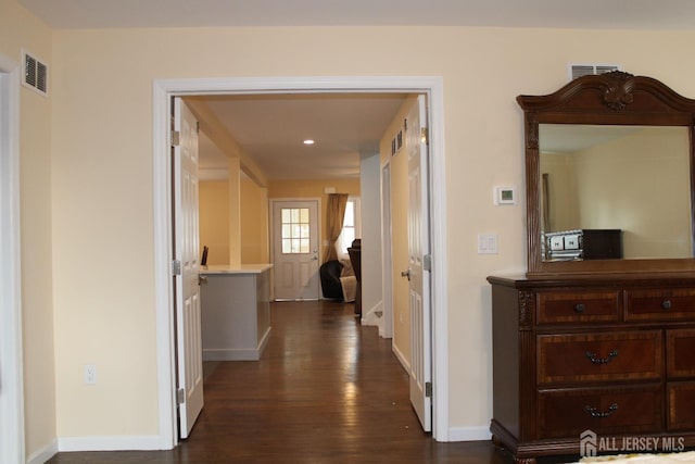 corridor featuring dark wood-type flooring