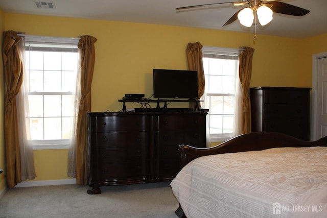 bedroom with light colored carpet and ceiling fan