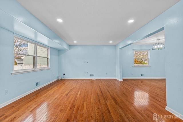 interior space with baseboards, visible vents, and wood-type flooring