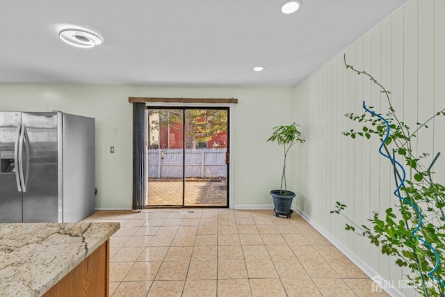 interior space with light tile patterned floors, baseboards, and recessed lighting