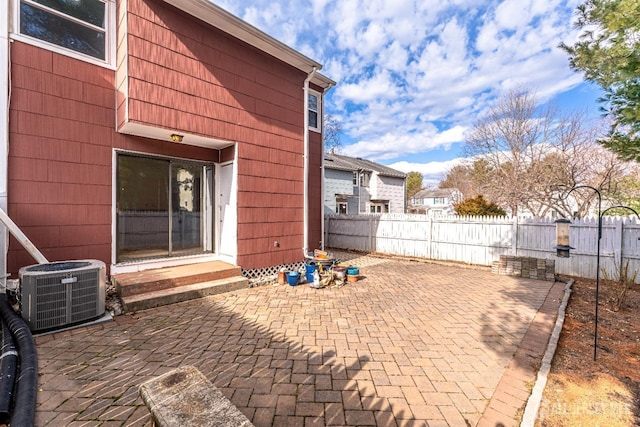 view of patio / terrace with central air condition unit, entry steps, and fence