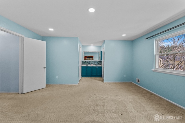 unfurnished bedroom with light colored carpet, recessed lighting, visible vents, and baseboards