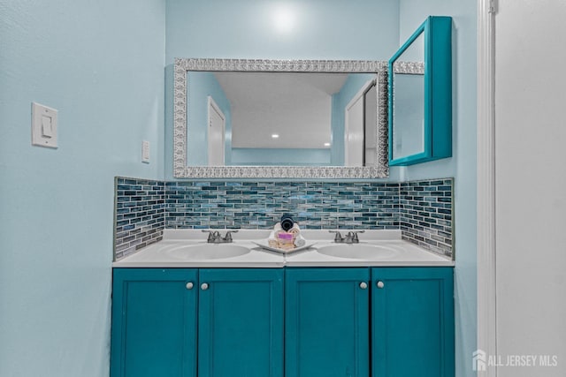 full bath featuring tasteful backsplash, double vanity, and a sink