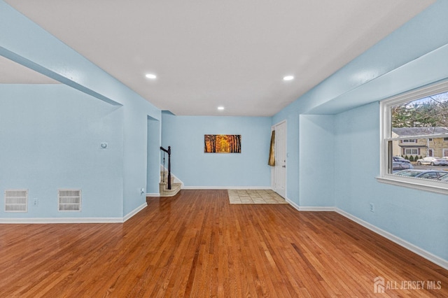 interior space featuring recessed lighting, visible vents, baseboards, and wood finished floors