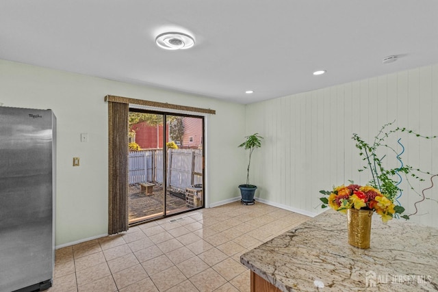 unfurnished dining area featuring light tile patterned flooring, recessed lighting, and baseboards