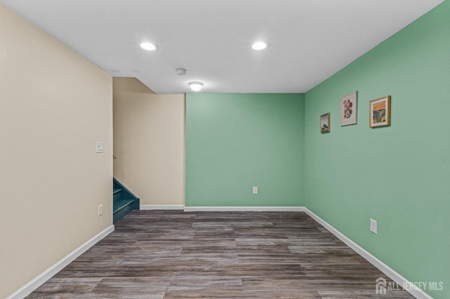 unfurnished room with recessed lighting, baseboards, and wood finished floors