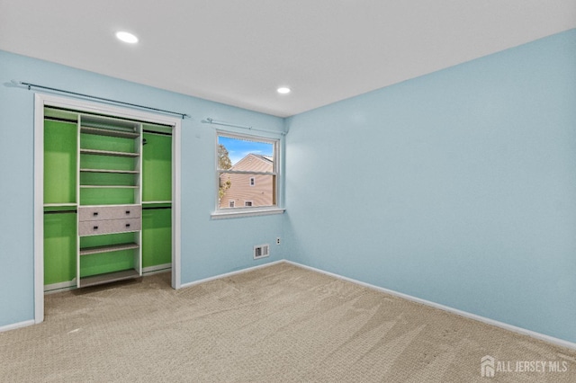 unfurnished bedroom featuring visible vents, baseboards, carpet flooring, recessed lighting, and a closet