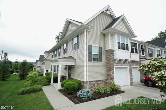 1 Burdett Ln, Verona, NJ 07044 - view of property exterior with stone siding, driveway, a garage, and a lawn