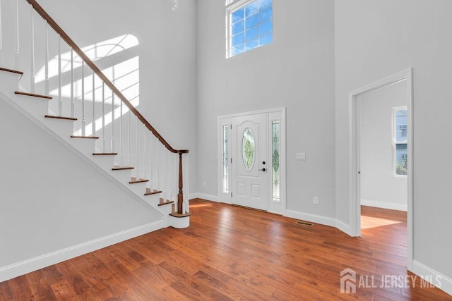 foyer entrance featuring a high ceiling and hardwood / wood-style floors