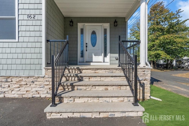 view of exterior entry with covered porch